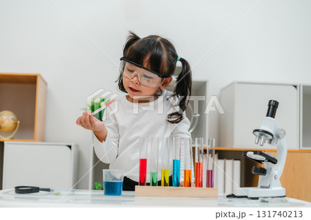 toddler girl scientist study using pipette dropping liquid with test tube and beaker. learning science toddler girl scientist study using pipette dropping liquid with test tube and beaker. learning science 131740213