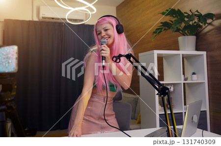 Beautiful young singer and musician broadcast from her home studio 131740309