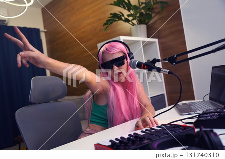 Beautiful young singer and musician broadcast from her home studio Beautiful young singer and musician broadcast from her home studio 131740310