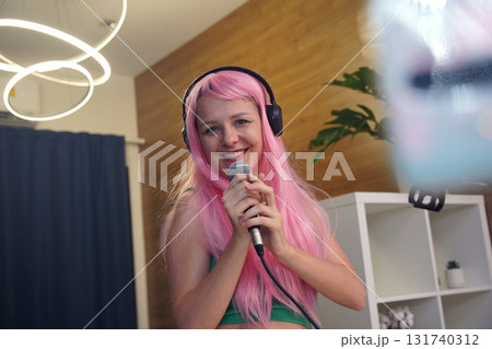 Beautiful young singer and musician broadcast from her home studio Beautiful young singer and musician broadcast from her home studio 131740312