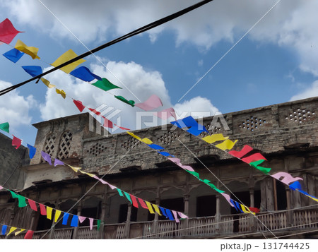 Abandoned Wooden Heritage Structure In Rawalpindi With Colorful Flags Fluttering Against Bright Morning Sky 131744425