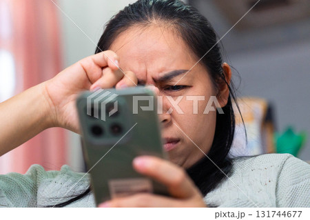 Asian Woman Feeling Eye Strain from Using Smartphone Asian Woman Feeling Eye Strain from Using Smartphone 131744677