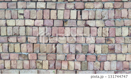 Close up view of a brick wall with light brown and tan colored bricks Close up view of a brick wall with light brown and tan colored bricks 131744747