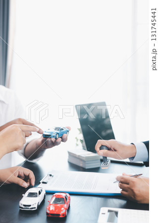 Businessman stamping approved contract for car loan agreement, concept of finance approval, vehicle purchase, leasing, or insurance, symbol of trust, validation, professional deal. approved contract. 131745441