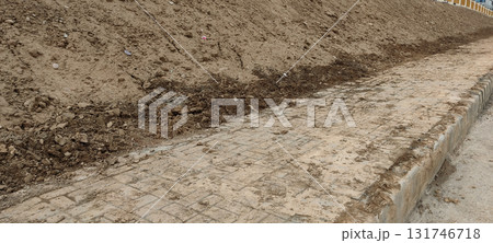 Sidewalk Covered with Pile of Dust and Soil During Daytime Depicting Dirty Street Path in Urban Environment Sidewalk Covered with Pile of Dust and Soil During Daytime Depicting Dirty Street Path in Urban Environment 131746718