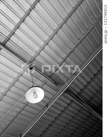 Industrial Metal Ceiling with Hanging White Light Fixture Industrial Metal Ceiling with Hanging White Light Fixture 131746915