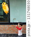 A playful scene capturing a moment of childhood wonder and curiosity 131748030