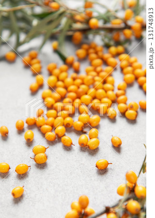 Sea buckthorn berries scattered on gray background Sea buckthorn berries scattered on gray background 131748913