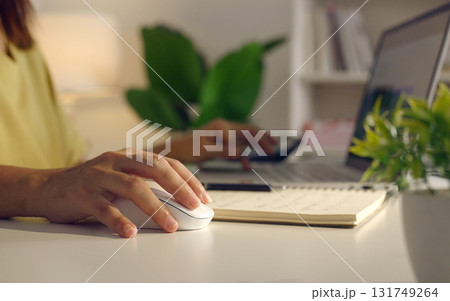 Close up woman hand click on wireless computer mouse working online on laptop computer at home surfing internet searching information internet network digital technology. Close up woman hand click on wireless computer mouse working online on laptop computer at home surfing internet searching information internet network digital technology. 131749264