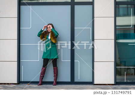 portrait of an elegantly dressed business woman at a glazed building in a financial district 131749791