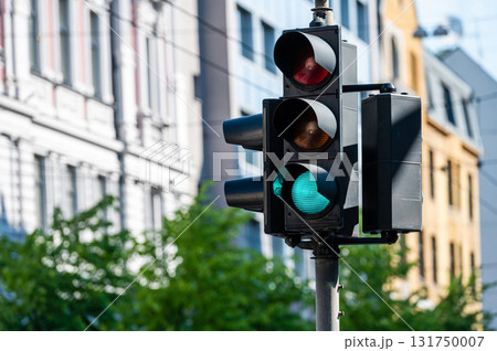 traffic semaphore with green light on the background of defocused urban street 131750007