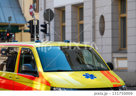 a yellow ambulance emergency car parked on the side of a crowded street, close up, selective focus a yellow ambulance emergency car parked on the side of a crowded street, close up, selective focus 131750009