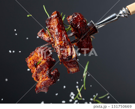 Grilled pork belly with rosemary on a fork. 131750669