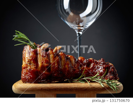 Grilled pork ribs with rosemary on a wooden board. Grilled pork ribs with rosemary on a wooden board. 131750670