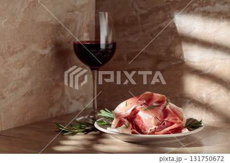 Prosciutto or Spanish jamon with rosemary and red wine. Prosciutto or Spanish jamon with rosemary and red wine. 131750672