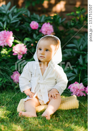 Baby Sitting Among Pink Flowers Outdoors 131751507