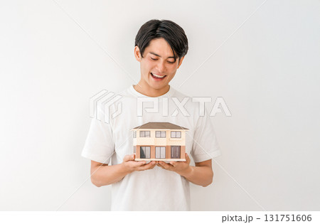 住宅模型を持つ笑顔の若いアジア人男性(マイホーム,一戸建て,家づくり) 住宅模型を持つ笑顔の若いアジア人男性(マイホーム,一戸建て,家づくり) 131751606