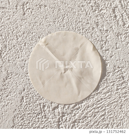 Round white patch on textured wall surface in bright sunlight Round white patch on textured wall surface in bright sunlight 131752462