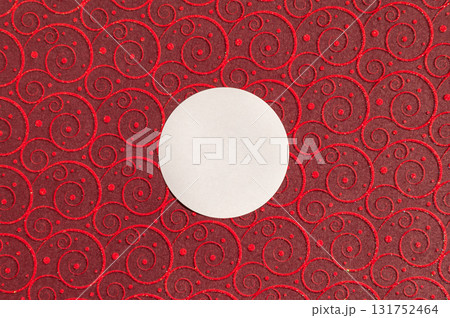White circle on red swirl patterned background with glitter accents White circle on red swirl patterned background with glitter accents 131752464