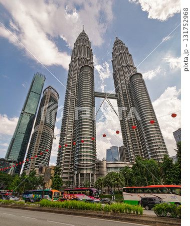 Petronas Twin Towers and modern skyscrapers in Kuala Lumpur, Malaysia, with street traffic and red lanterns. 131752968