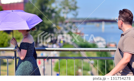 Warsaw, Poland. 15 August 2025. Tourists and  residents crossing crowded Swietokrzyski Bridge. Groups of people walking together crossing a bridge on a weekend day.  131754278