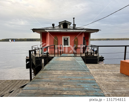 Wooden building on the background of a lake on an autumn day Wooden building on the background of a lake on an autumn day 131754811