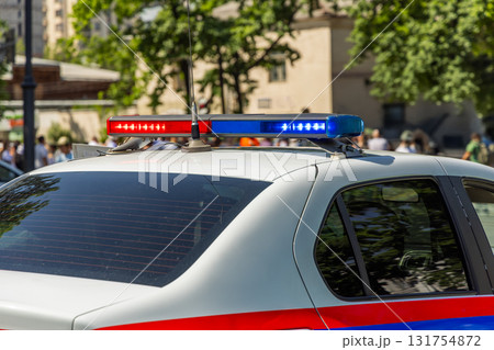 police car with lights on city street during daytime 131754872