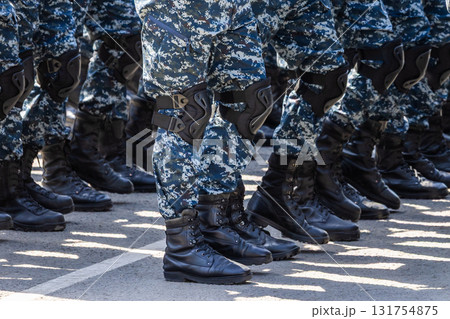 Multiple legs in urban camouflage gear standing in formation outdoors Multiple legs in urban camouflage gear standing in formation outdoors 131754875