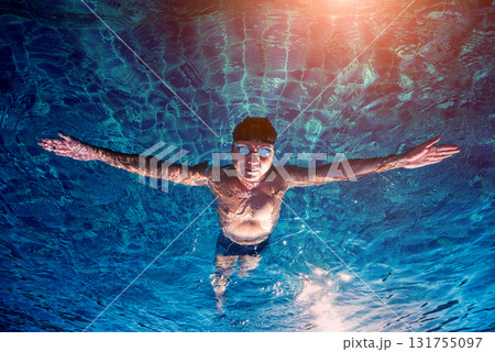 Young athletic man swimming in the swimming pool 131755097