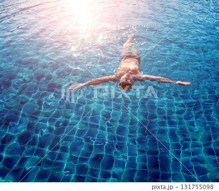 Young athletic man swimming in the swimming pool 131755098