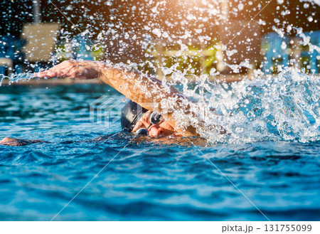 Young athletic man swimming in the swimming pool 131755099