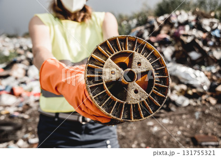 Woman volunteer helps clean the field of nuclear waste and plastic garbage Woman volunteer helps clean the field of nuclear waste and plastic garbage 131755321