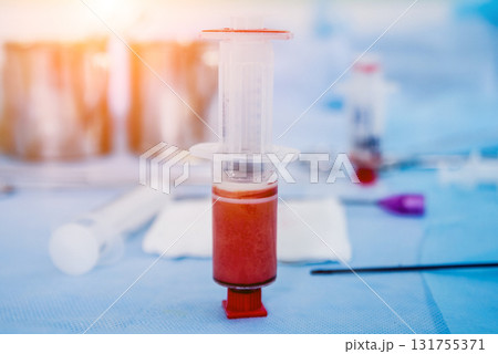 Platelet-Rich plasma preparation. Plasma in syringe. Centrifuge. Platelet-Rich plasma preparation. Plasma in syringe. Centrifuge. 131755371