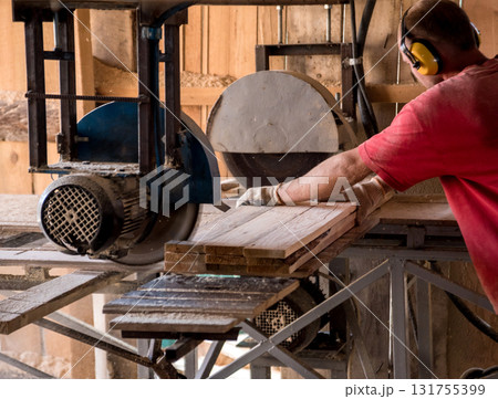 Modern sawmill. A carpenter works on woodworking the machine tool. Modern sawmill. A carpenter works on woodworking the machine tool. 131755399