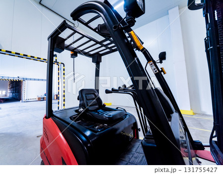 Forklift in a large industrial freezer warehouse. Forklift in a large industrial freezer warehouse. 131755427