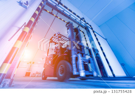 Forklift in a large industrial freezer warehouse. 131755428