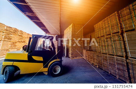 Forklift loader load lumber into a dry kiln. Wood drying in containers. 131755474
