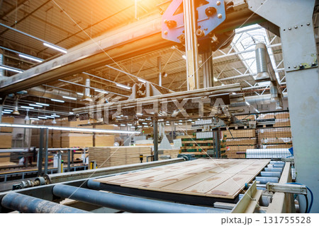 Production line of the wooden floor factory. CNC automatic woodworking machine. Production line of the wooden floor factory. CNC automatic woodworking machine. 131755528