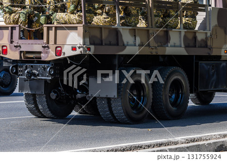 Soldiers in camouflage uniforms sitting in military truck outdoors 131755924