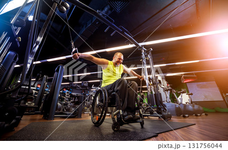 Disabled man training in the gym of rehabilitation center Disabled man training in the gym of rehabilitation center 131756044
