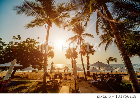 Beautiful tropical beach with palm trees. Sunrises and sunsets. Ocean. 131756219