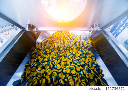 Automatic filling machine pours water into plastic PET bottles.  131756272