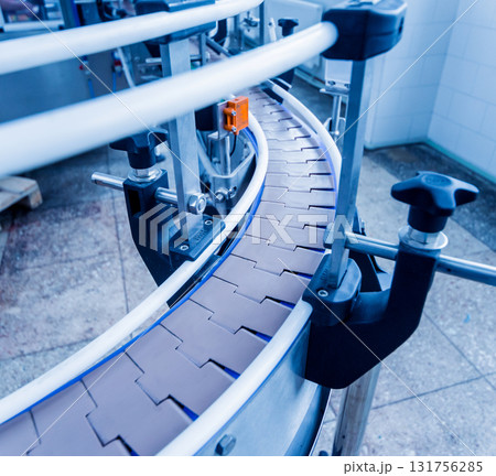 Automatic filling machine pours water into plastic PET bottles. Automatic filling machine pours water into plastic PET bottles. 131756285