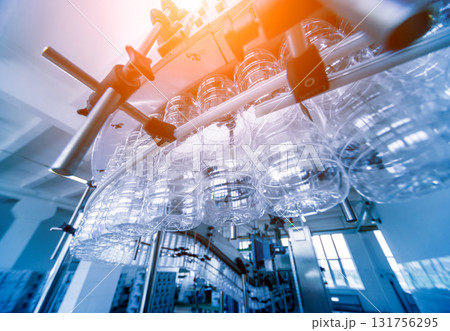 Bottling line of sunflower oil in bottles. Vegetable oil production plant. Bottling line of sunflower oil in bottles. Vegetable oil production plant. 131756295