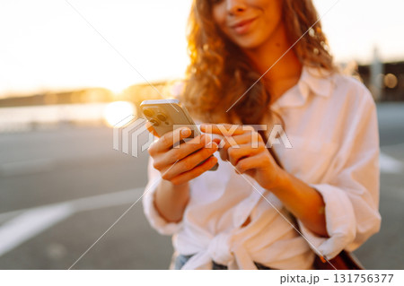 Phone in woman's hands. Communication with friends. Travel, tourism, technology, blogging concept. Phone in woman's hands. Communication with friends. Travel, tourism, technology, blogging concept. 131756377