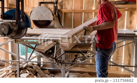 Modern sawmill. A carpenter works on woodworking the machine tool. Modern sawmill. A carpenter works on woodworking the machine tool. 131756602