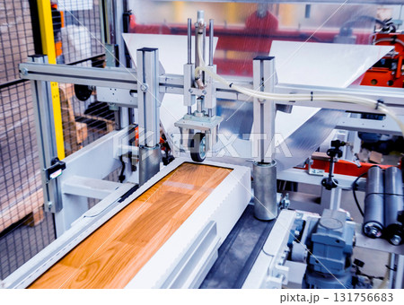 Production line of the wooden floor factory. CNC automatic woodworking machine. Production line of the wooden floor factory. CNC automatic woodworking machine. 131756683