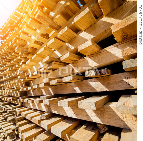 Stack of natural rough wooden boards. Wooden boards, lumber, industrial wood. 131756701
