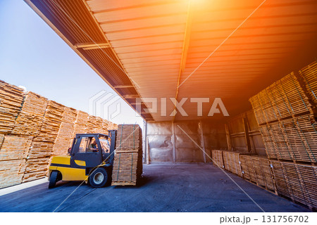 Forklift loader load lumber into a dry kiln. Wood drying in containers. 131756702