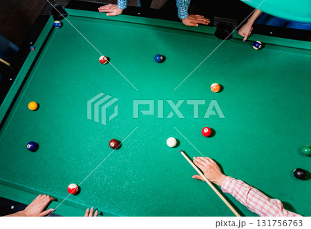 Young man trying to hit the ball in billiard. Young man trying to hit the ball in billiard. 131756763